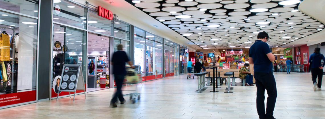 Menschen laufen durch einen modern aussehenden Gang der Shoppingmall Kontor Zum alten Speicher in Vegesack