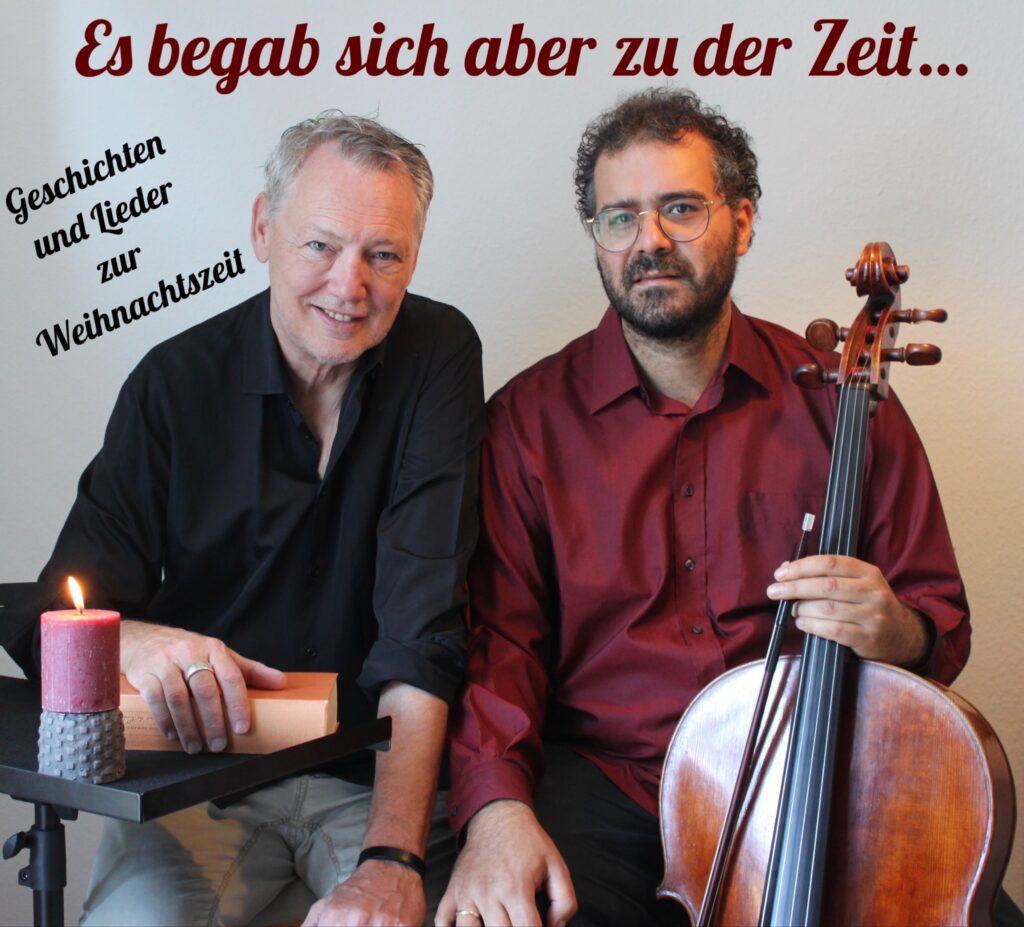 Zwei Männer der eine hat ein Cello in der Hand mit dem Spruch "Es begab sich aber zu der Zeit"